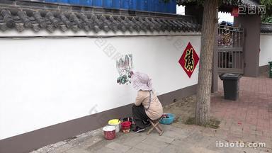 美术老师在农村作墙画